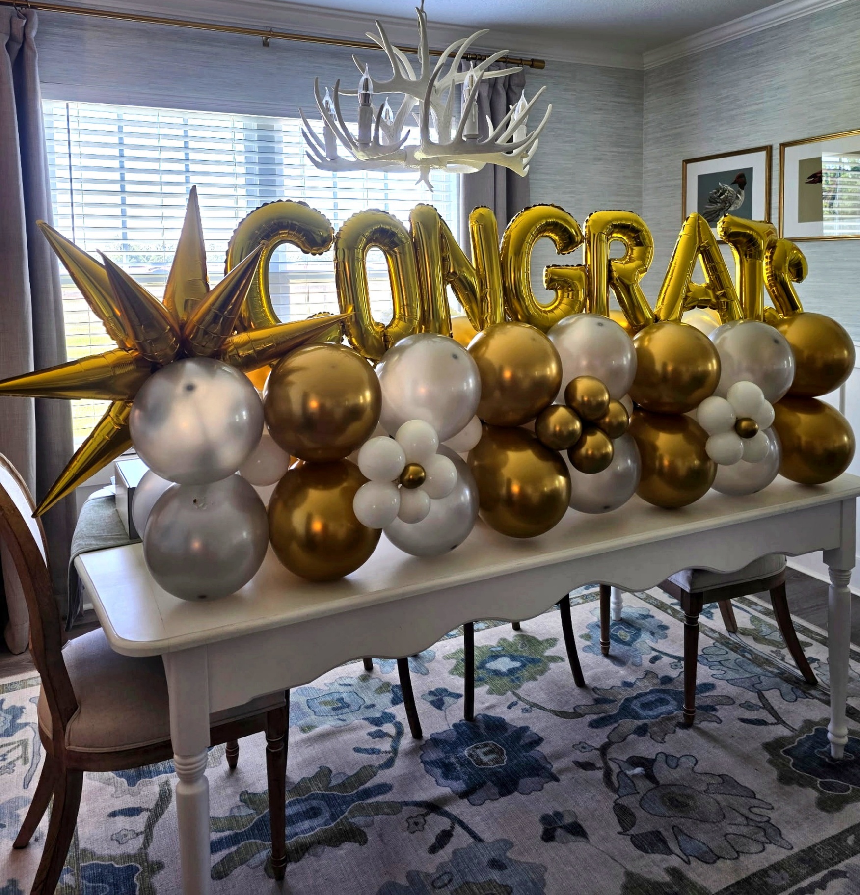Gold CONGRATS foil letters over a gold, silver and white balloon marquee